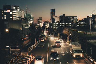 High angle view of traffic on road amidst buildings in city