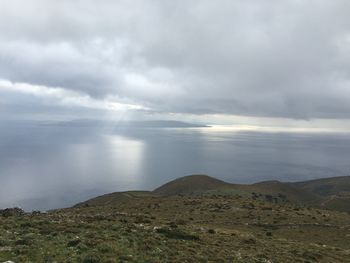 Scenic view of landscape against cloudy sky