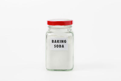Close-up of glass bottle against white background