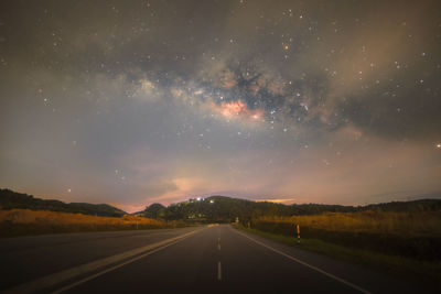 Scenic view of road against sky at night