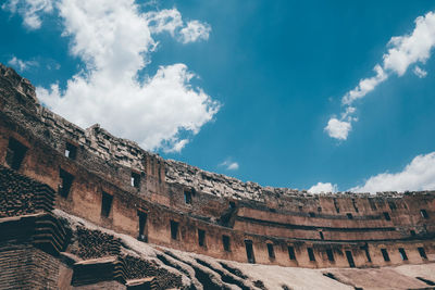 Low angle view of old building against cloudy sky