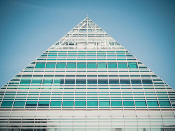 Low angle view of modern building against blue sky