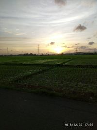 Scenic view of field against sky during sunset