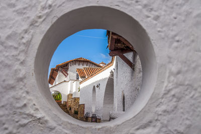 View of buildings through round window