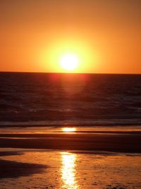 Scenic view of sea against romantic sky at sunset