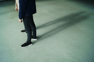 Low section of woman standing on tiled floor