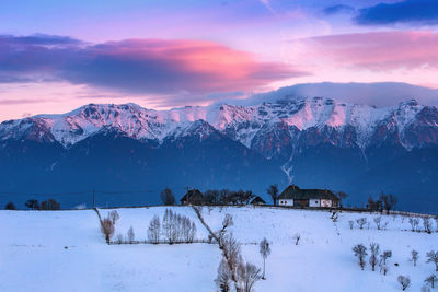 Scenic view of snowcapped mountains against sky during sunset