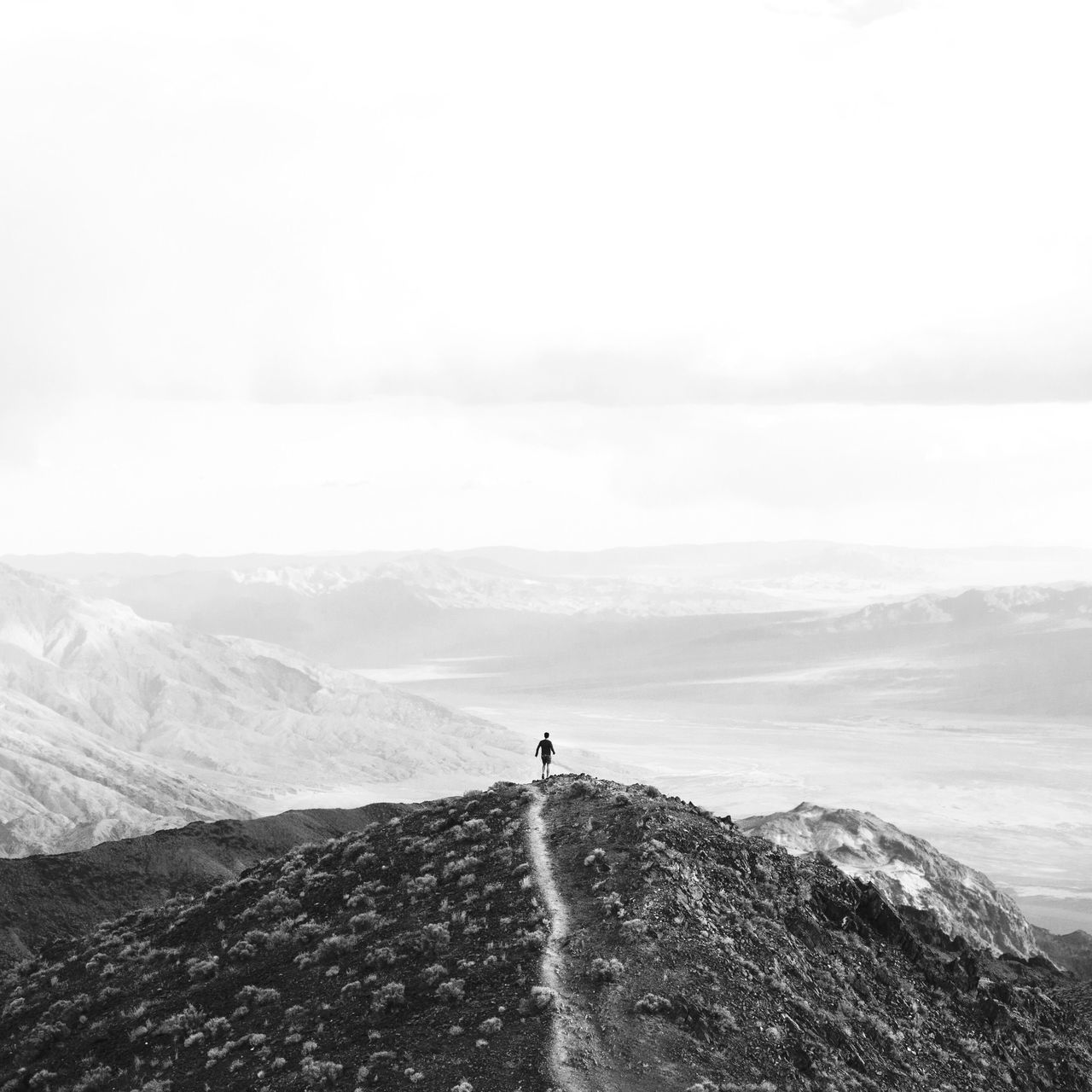 mountain, leisure activity, lifestyles, men, scenics, water, tranquil scene, full length, beauty in nature, unrecognizable person, tranquility, nature, standing, rear view, adventure, walking, sky, tourist