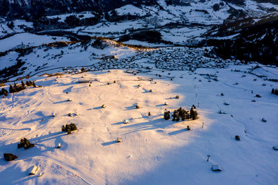Aerial  of townwith snow covered roofs. village in switzerland in winter with a lot of snow. laax