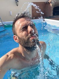 Portrait of young man in swimming pool