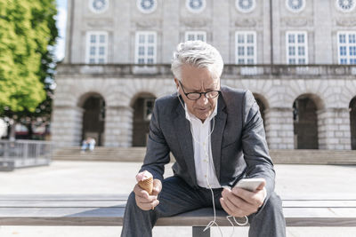 Full length of man using mobile phone