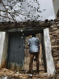 Rear view of man standing outside building