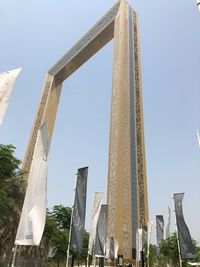 Low angle view of cranes against sky