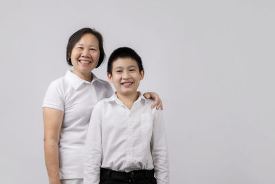 Portrait of a smiling young couple against white background