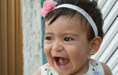 Portrait of cute girl laughing while looking away