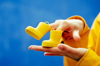 Midsection of woman holding thermometer