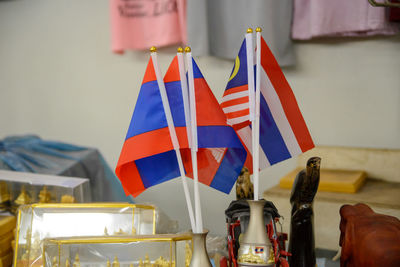 Close-up of flags against the wall