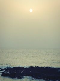 Scenic view of sea against clear sky during sunset