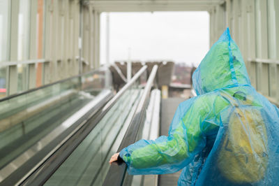 Rear view of woman standing in train