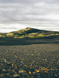 Scenic view of mountain against cloudy sky