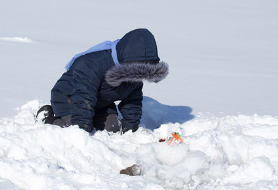 Rear view of man on snow covered land