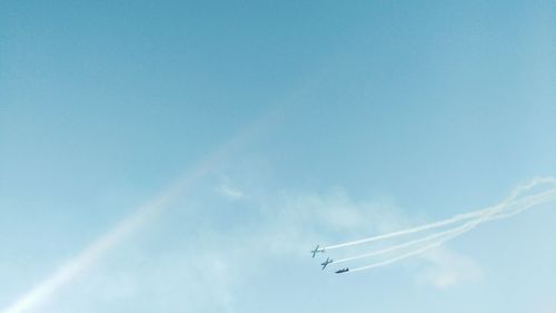 Low angle view of airshow in sky