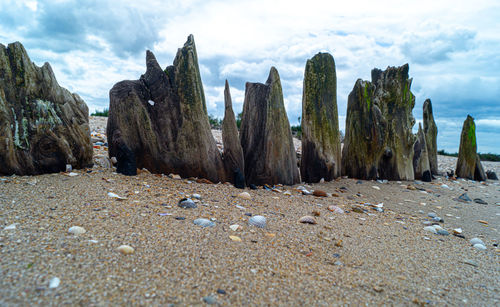 Panoramic shot of rocks on beach against sky