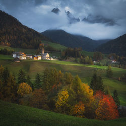 Scenic view of buildings and mountains against sky during autumn