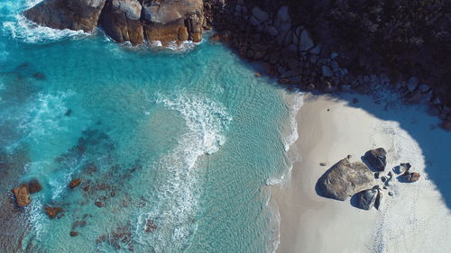 High angle view of rocks on sea shore