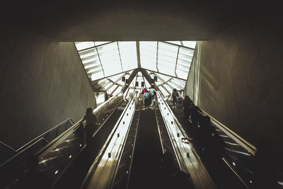 Low angle view of people on escalator