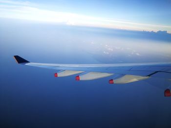 Airplane wing against sky