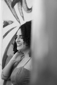 Portrait of young woman with reflection on wall