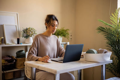 Woman using laptop at home