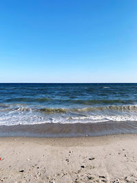 Scenic view of sea against clear blue sky