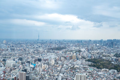 High angle view of city against cloudy sky