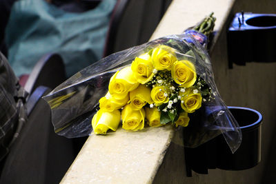 High angle view of yellow rose flowers bouquet on retaining wall