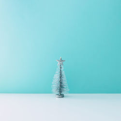 Christmas decoration on table against blue wall