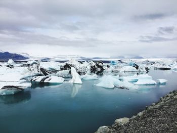 Scenic view of frozen lake against sky