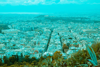 High angle view of crowd by sea against buildings in city