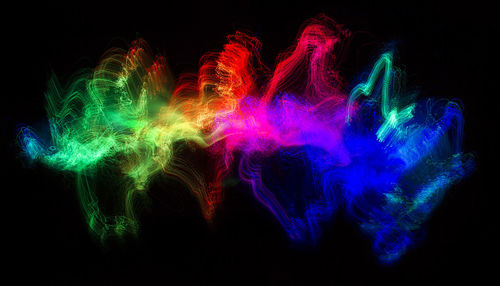 Multi colored light painting against black background