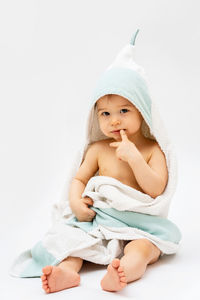 Portrait of cute baby girl against white background