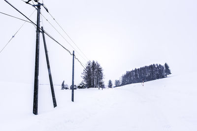 Ski lift against clear sky during winter