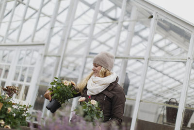 Smiling woman in greenhouse