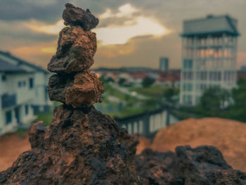 Close-up of stone stack on rock against sky