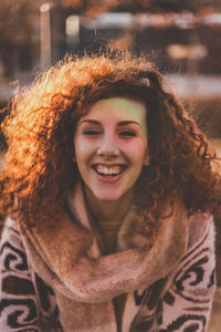 Close-up portrait of smiling woman in warm clothing