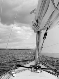 Sailboat sailing on sea against sky