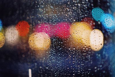 Close-up of wet glass window in rainy season