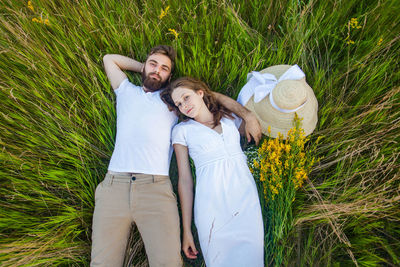 Couple kissing on field