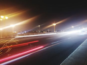 Light trails on road in city at night