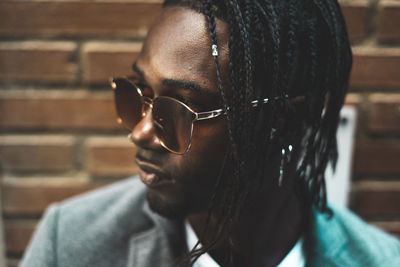 Close-up portrait of young man wearing sunglasses